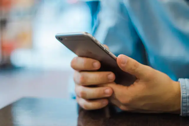 Person holding a smartphone in both hands